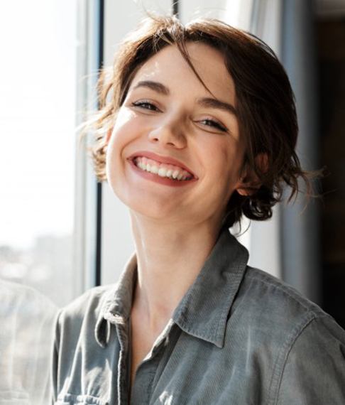 Patient smiling after getting a dental bridge