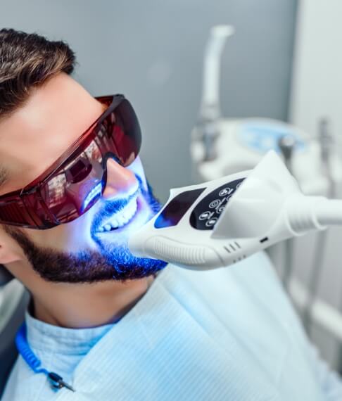 Patient receiving in office teeth whitening