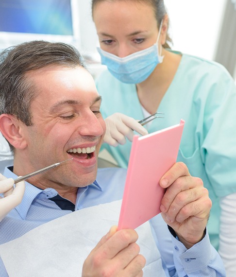 A man looking at his dental crown
