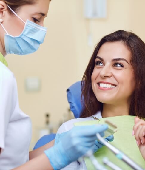 Dental team member and patient discussing the cost of dental implants