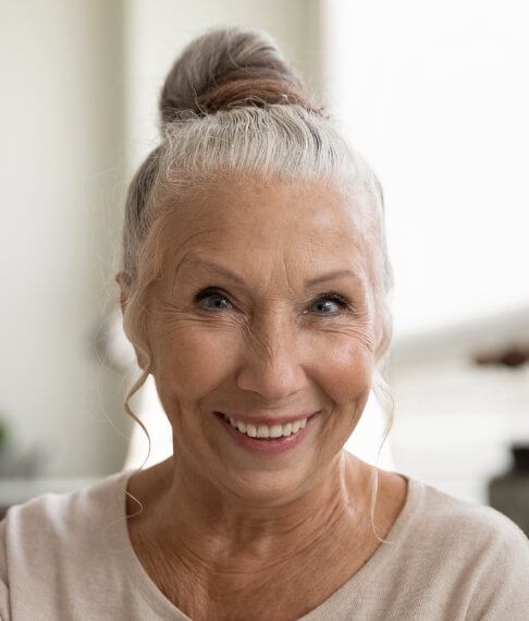 Woman smiling after visiting the dental insurance denitst