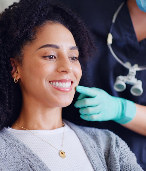 Woman smiling after receiving tooth-colored fillings in Washington