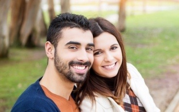 Man and woman with healthy smiles after preventive dentistry