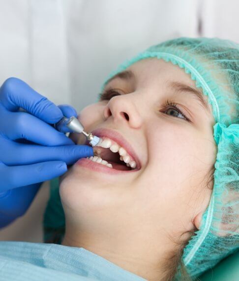 Young dental patient receiving fluoride treatment