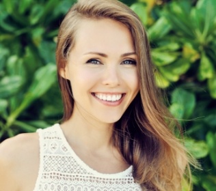 Woman with aligned smile after Invisalign orthodontic treatment