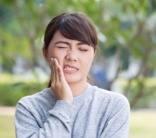 Woman in pain before emergency dentistry